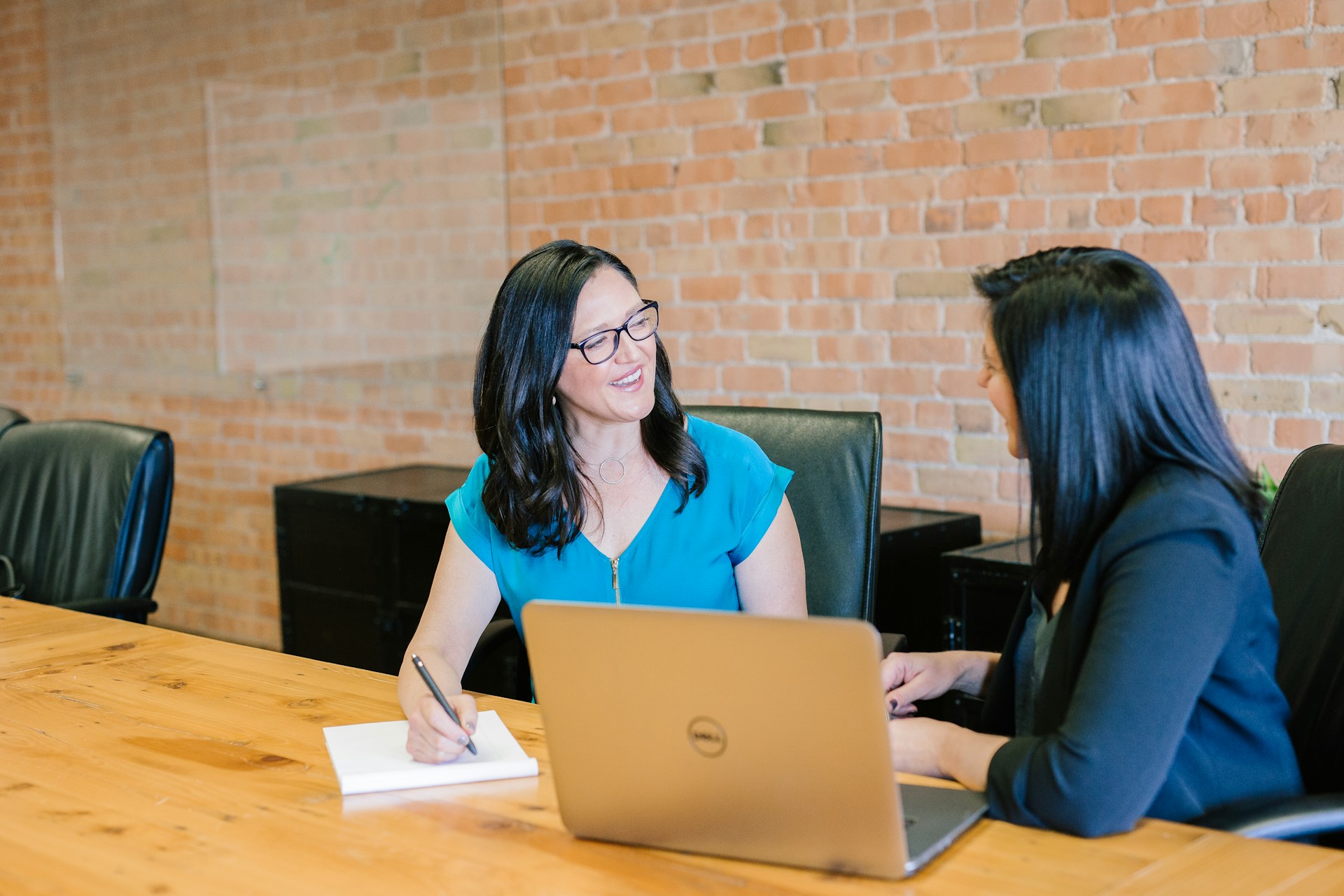 Blog 5 Two woman talking in an office environment.